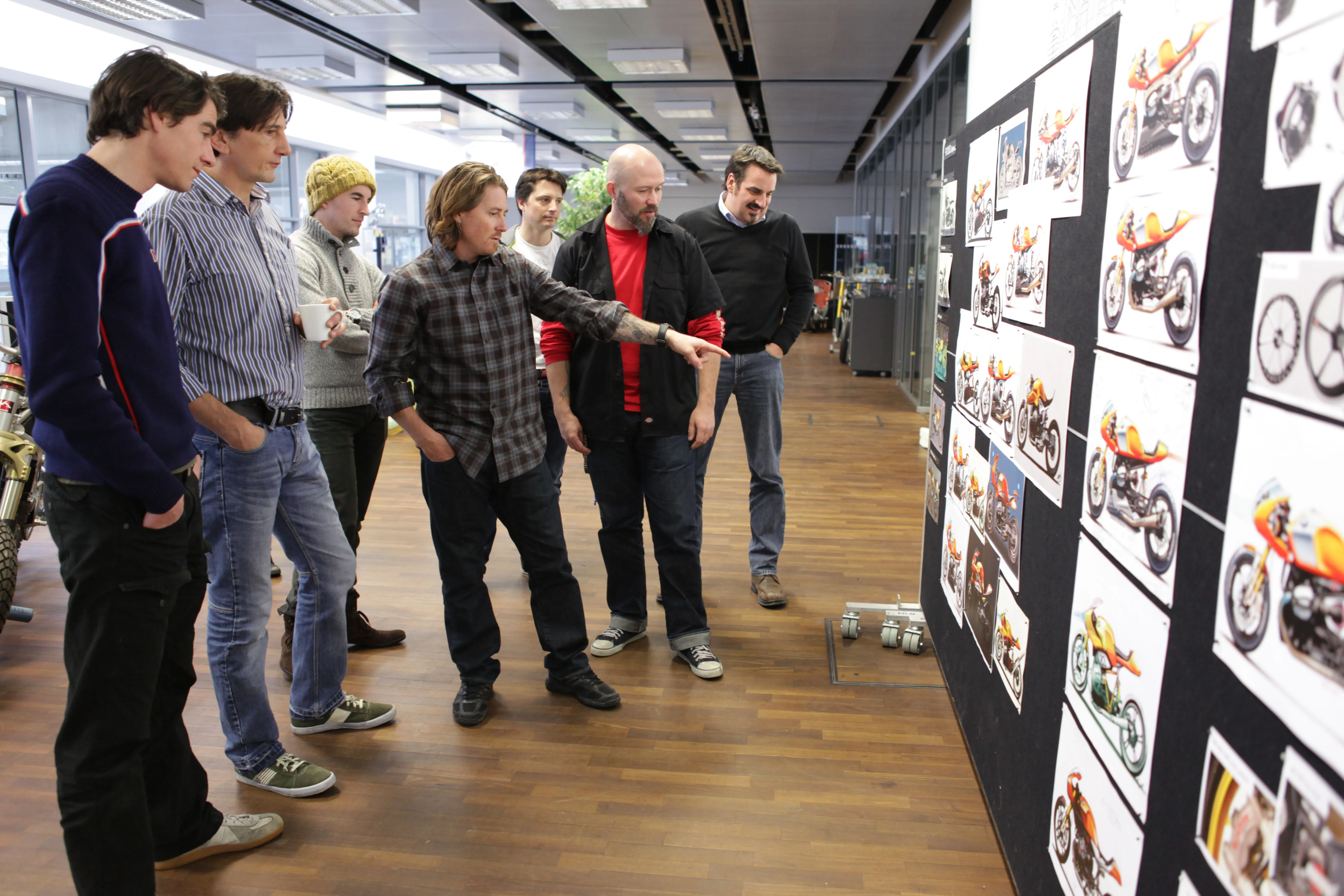 Leader standing before a digital display